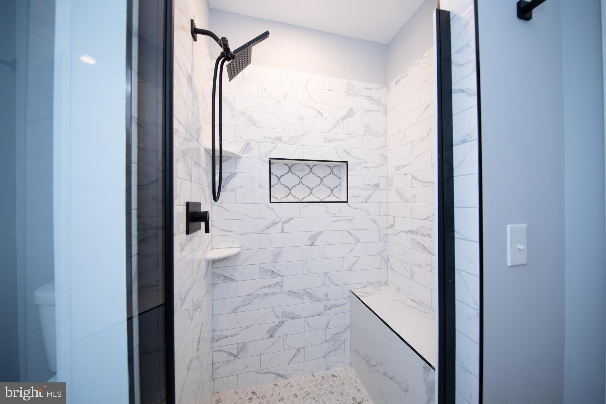 416 Dunkirk Road Baltimore, MD 21212 - Photo 15 of 33 a view of a bathroom with a shower and a mirror