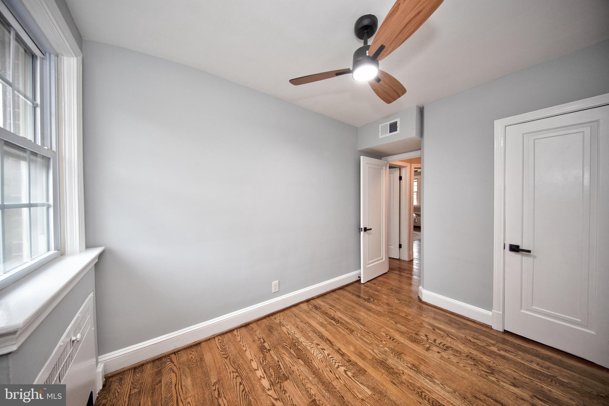 416 Dunkirk Road Baltimore, MD 21212 - Photo 20 of 33 wooden floor in an empty room with a window