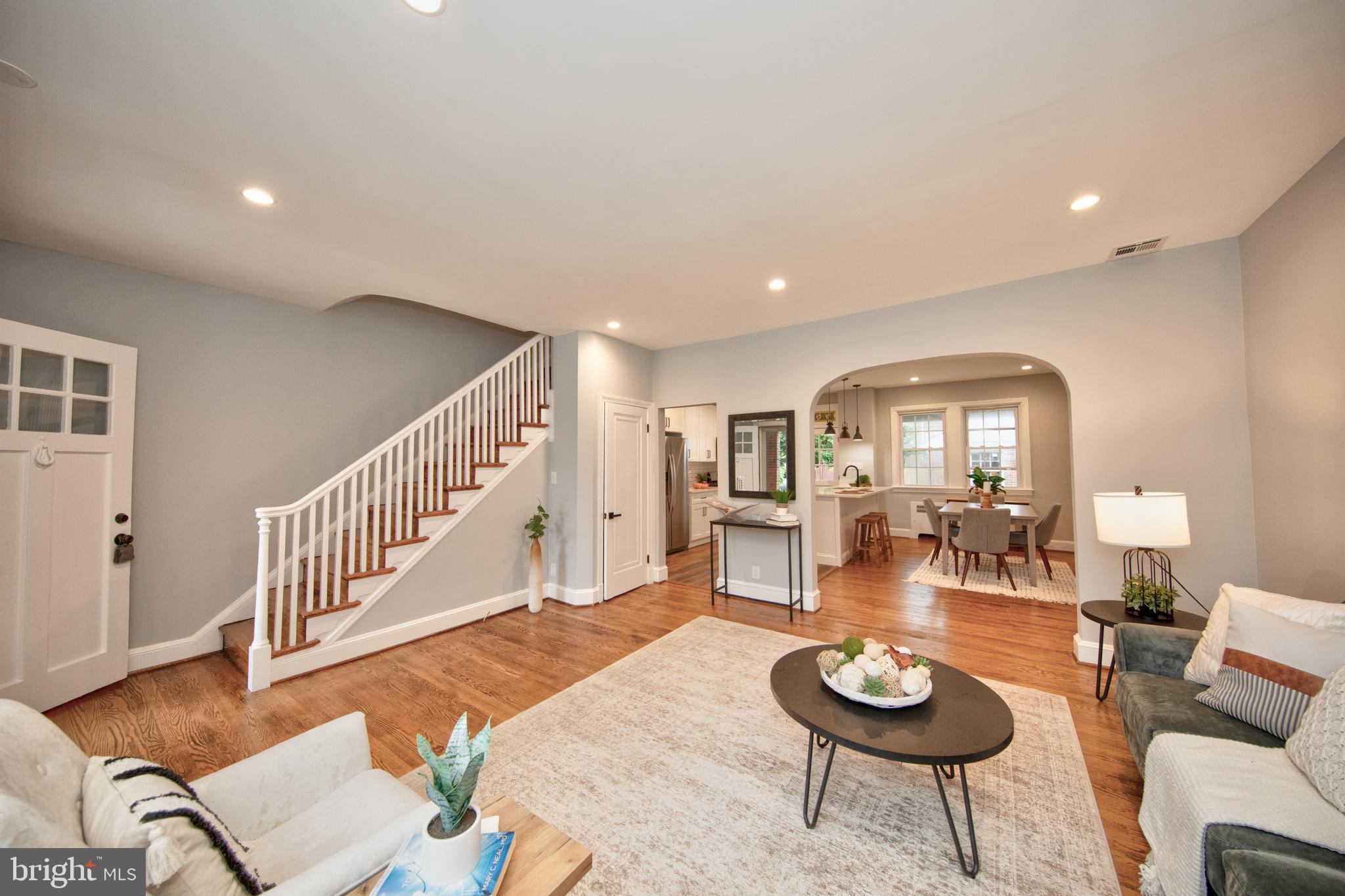 416 Dunkirk Road Baltimore, MD 21212 - Photo 2 of 33 a living room with furniture and a dining table with wooden floor