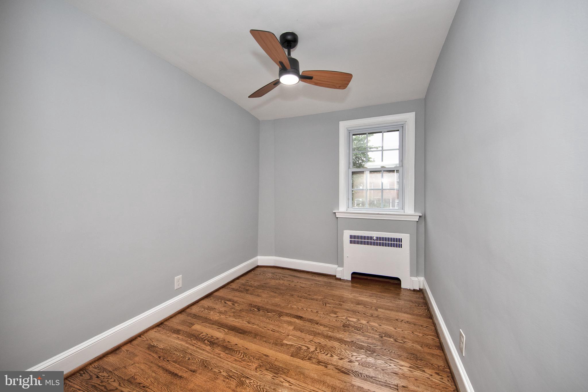 416 Dunkirk Road Baltimore, MD 21212 - Photo 21 of 33 a view of empty room with wooden floor and window