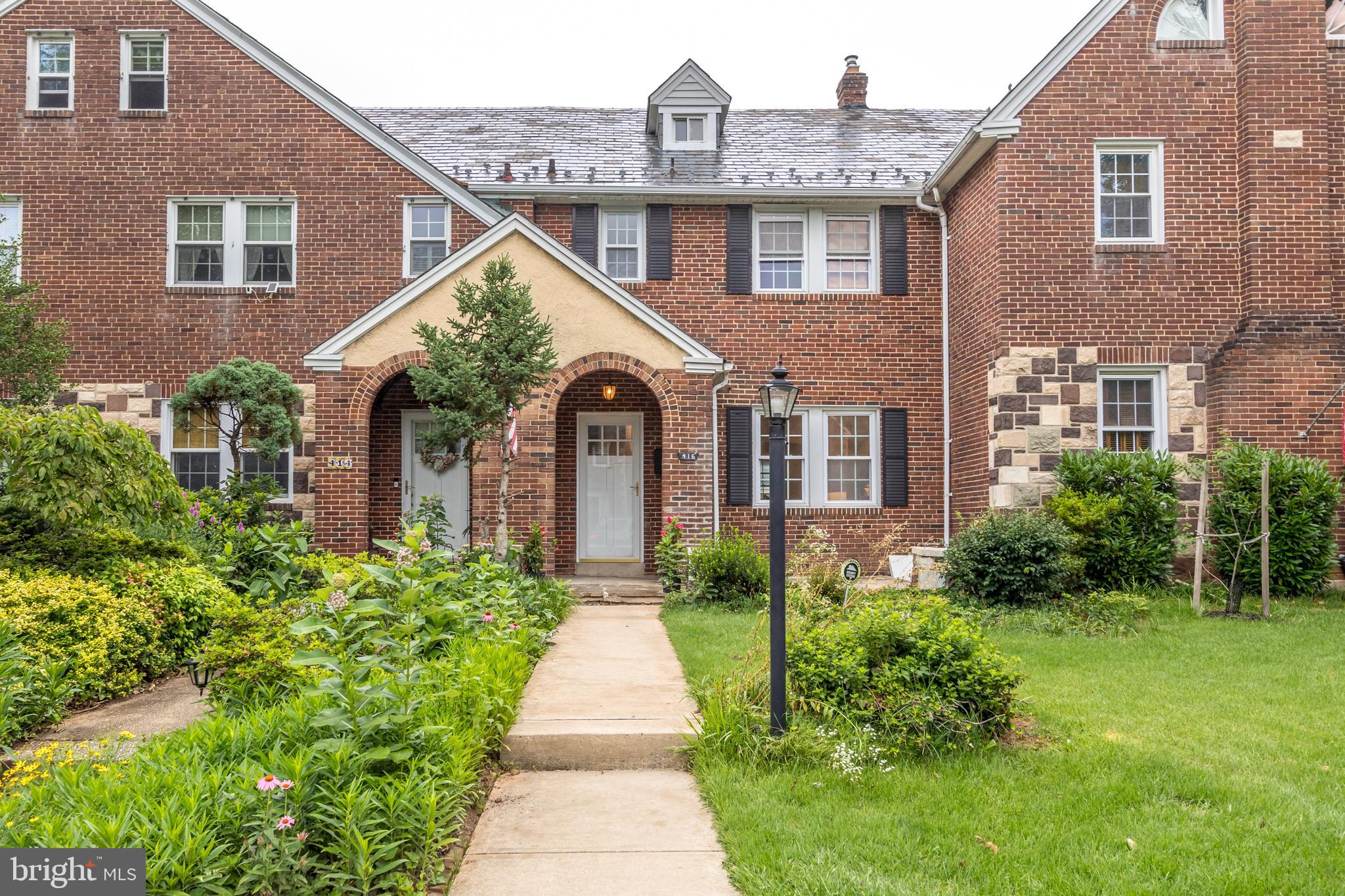416 Dunkirk Road Baltimore, MD 21212 - Photo 32 of 33 a front view of a house with a yard and potted plants
