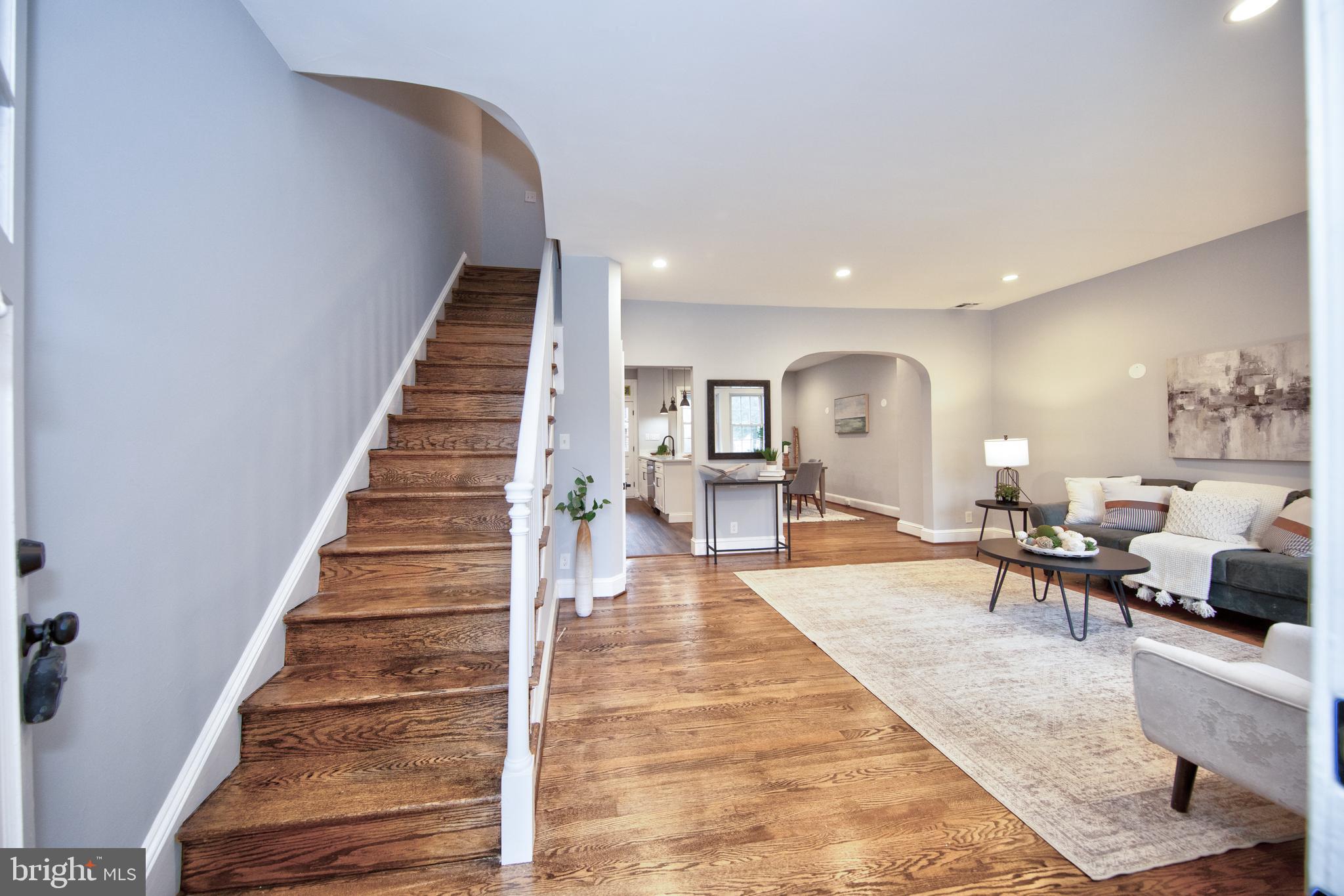 416 Dunkirk Road Baltimore, MD 21212 - Photo 6 of 33 a living room with furniture and a dining table with wooden floor