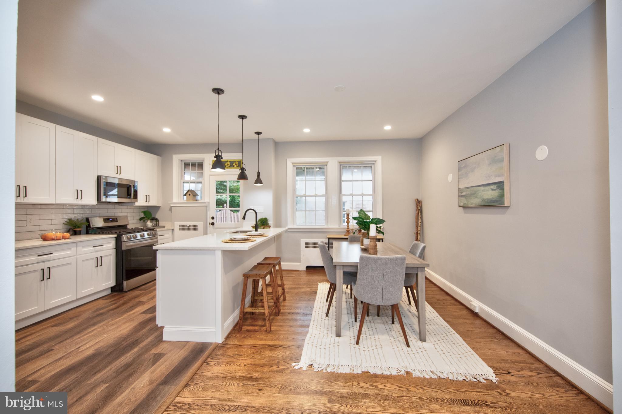 416 Dunkirk Road Baltimore, MD 21212 - Photo 7 of 33 a living room with stainless steel appliances kitchen island granite countertop furniture a rug kitchen view and a chandelier