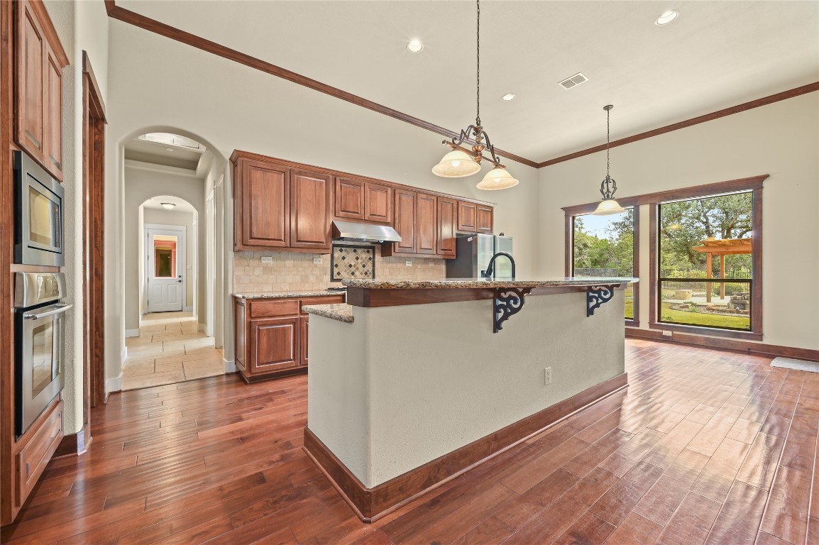 351 Hawthorne Loop Driftwood, TX 78619 - Photo 13 of 39 a living room with stainless steel appliances granite countertop furniture wooden floor and a large window