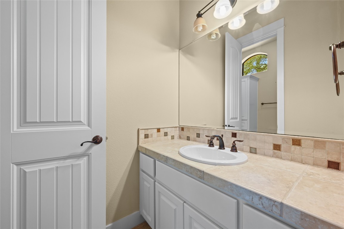 351 Hawthorne Loop Driftwood, TX 78619 - Photo 22 of 39 a bathroom with a sink and a mirror
