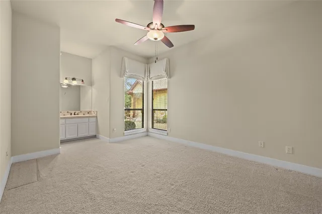 a bathroom with a double vanity sink mirror and toilet