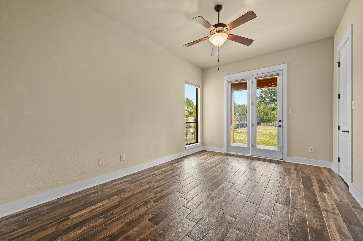 351 Hawthorne Loop Driftwood, TX 78619 - Photo 25 of 39 a view of room with window ceiling fan and hardwood floor