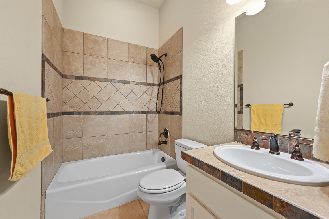 351 Hawthorne Loop Driftwood, TX 78619 - Photo 26 of 39 a bathroom with a sink toilet and shower