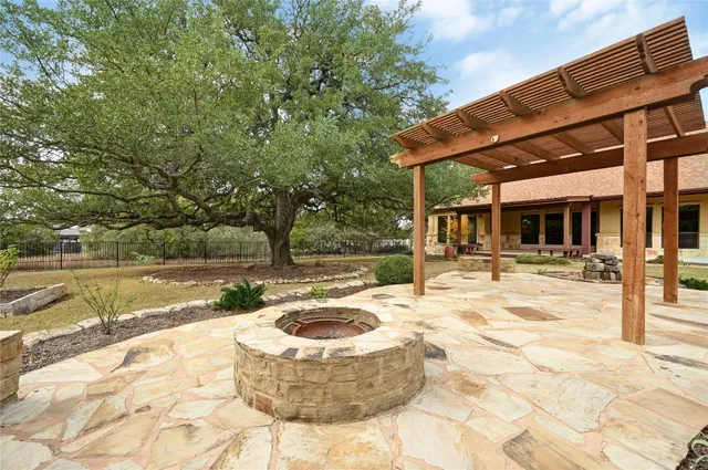 a view of house with yard and car parked