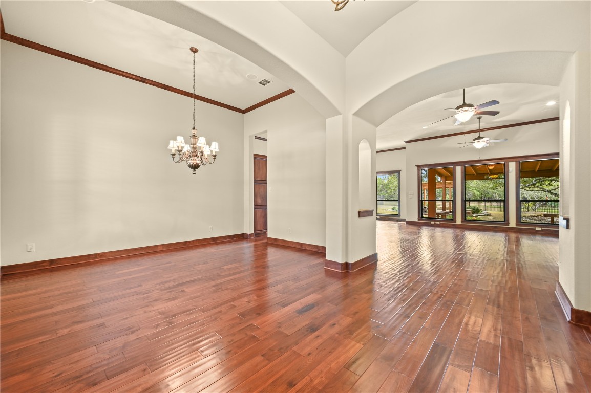 351 Hawthorne Loop Driftwood, TX 78619 - Photo 4 of 39 a view of empty room with wooden floor and fan