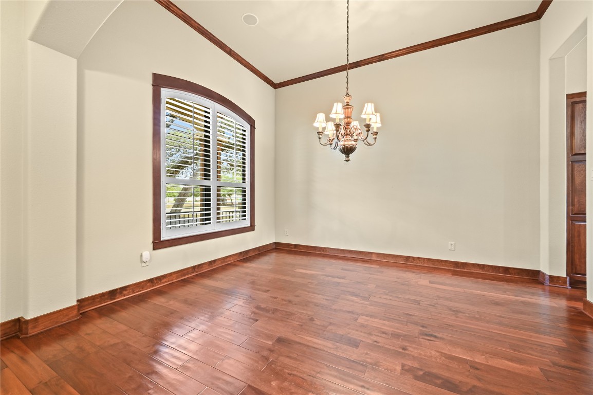 351 Hawthorne Loop Driftwood, TX 78619 - Photo 6 of 39 a view of a big room with wooden floor and chandelier
