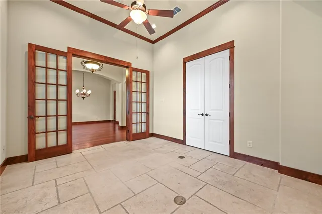 a view of a livingroom with furniture wooden floor a ceiling fan and windows