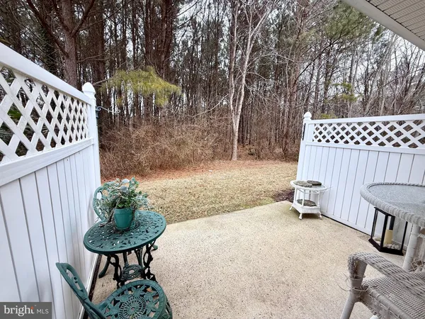 a view of a chair and table in backyard