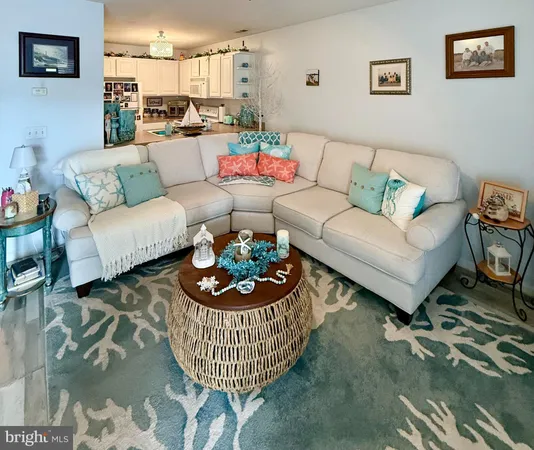 a living room with furniture and a dining table with wooden floor