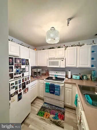 a kitchen with a stove a sink and a refrigerator