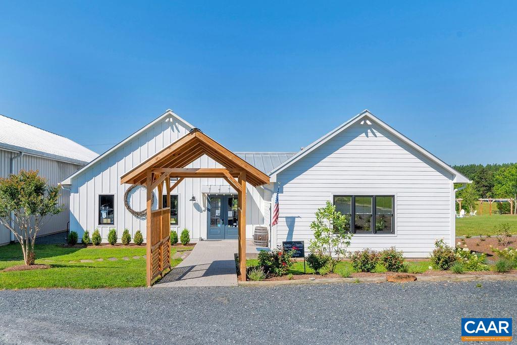 3304 A Ruritan Lake Road Palmyra, VA 22963 - Photo 34 of 37 a front view of a house with a yard and potted plants