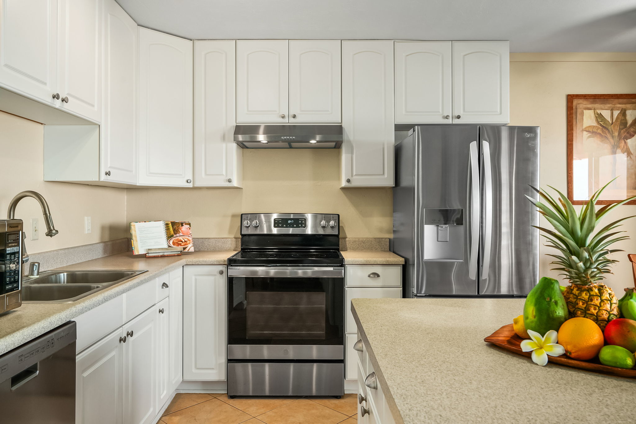 4451 Moana Road, Unit 309 Waimea, HI 96796 - Photo 4 of 21 a kitchen with stainless steel appliances granite countertop a stove a refrigerator and a sink