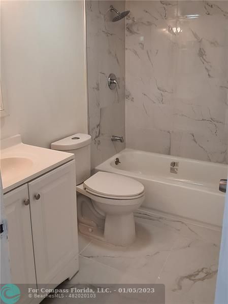 Welleby Sunrise, FL 33351 - Photo 5 of 10 a white toilet sitting next to a bathroom sink and a shower