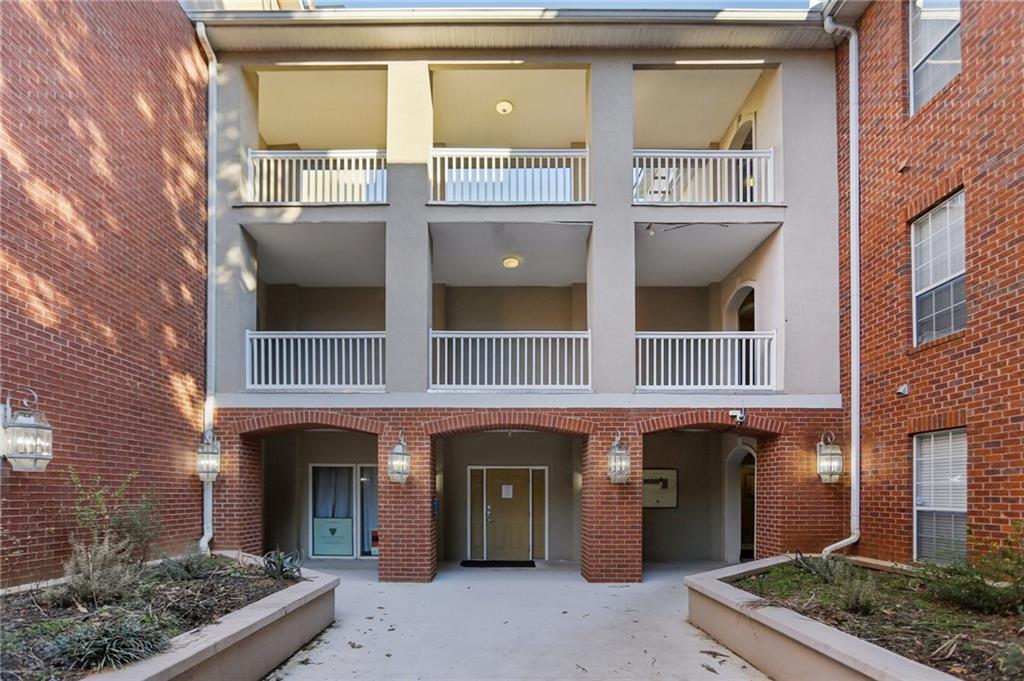 5641 Roswell Road, Unit 201 Atlanta, GA 30342 - Photo 11 of 14 a front view of a house with a yard