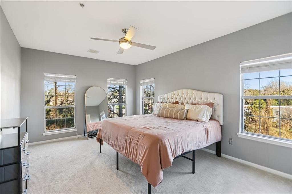 5641 Roswell Road, Unit 201 Atlanta, GA 30342 - Photo 4 of 14 a bedroom with a large bed and a window