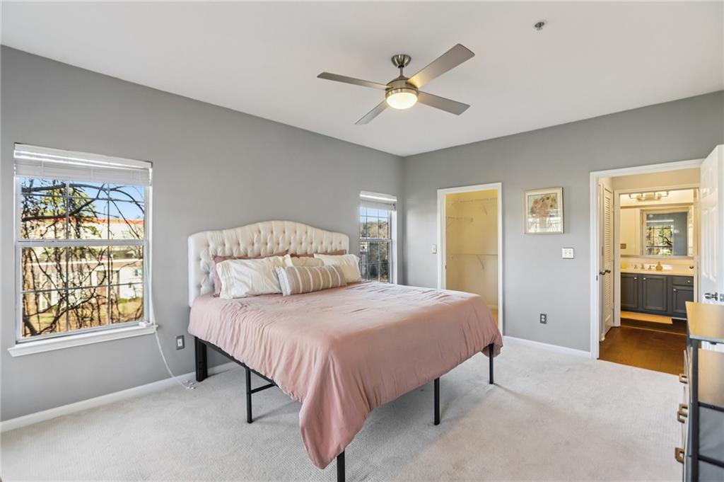 5641 Roswell Road, Unit 201 Atlanta, GA 30342 - Photo 8 of 14 a bedroom with a bed and a chandelier