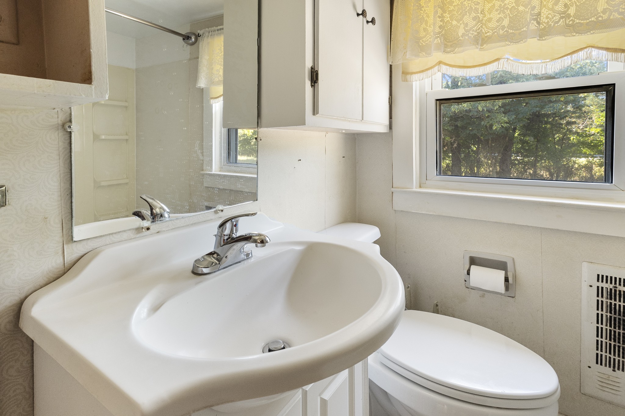 1210 Garton Road Burns, TN 37029 - Photo 30 of 32 a bathroom with a sink a toilet and a mirror