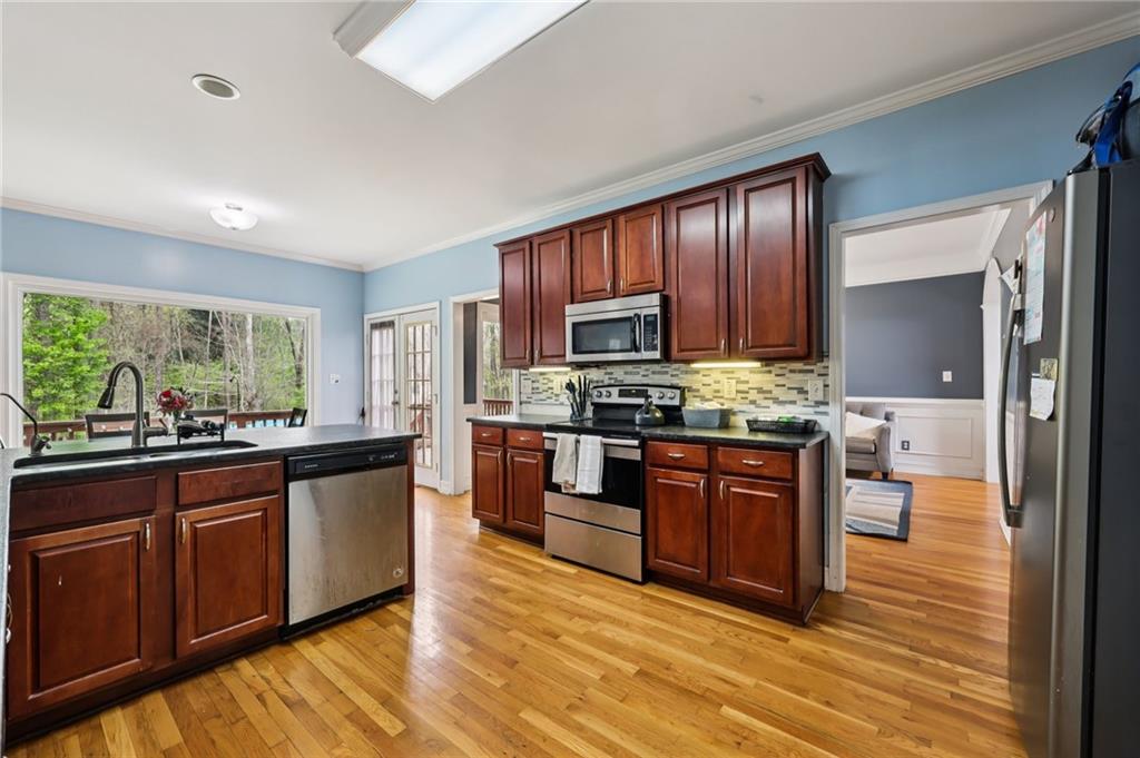436 Lancelot Trail McDonough, GA 30252 - Photo 16 of 49 a large kitchen with wooden floors and stainless steel appliances