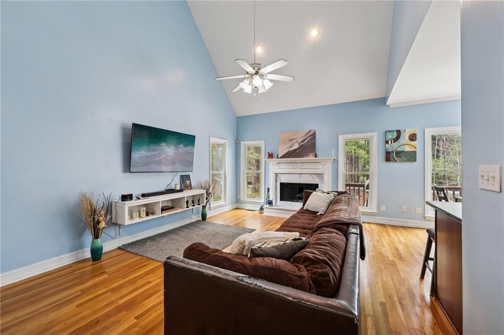 436 Lancelot Trail McDonough, GA 30252 - Photo 20 of 49 a living room with furniture a fireplace and a flat screen tv