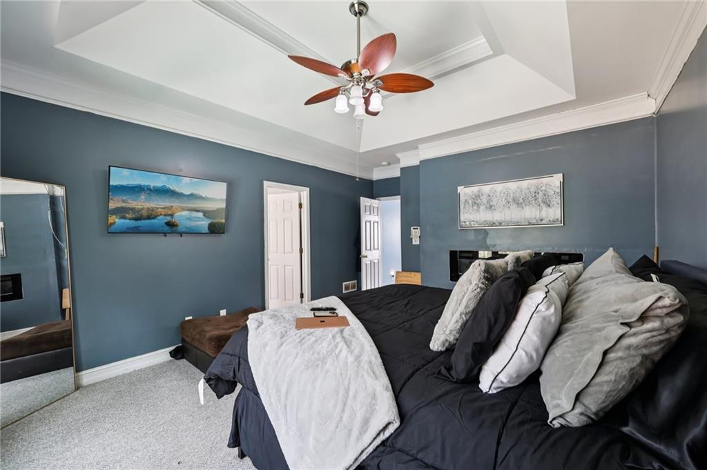 436 Lancelot Trail McDonough, GA 30252 - Photo 26 of 49 a bed room with bed and a chandelier