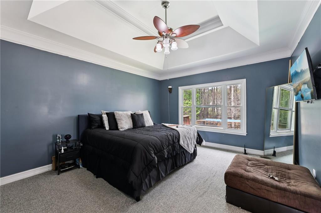 436 Lancelot Trail McDonough, GA 30252 - Photo 27 of 49 a spacious bedroom with a bed and window