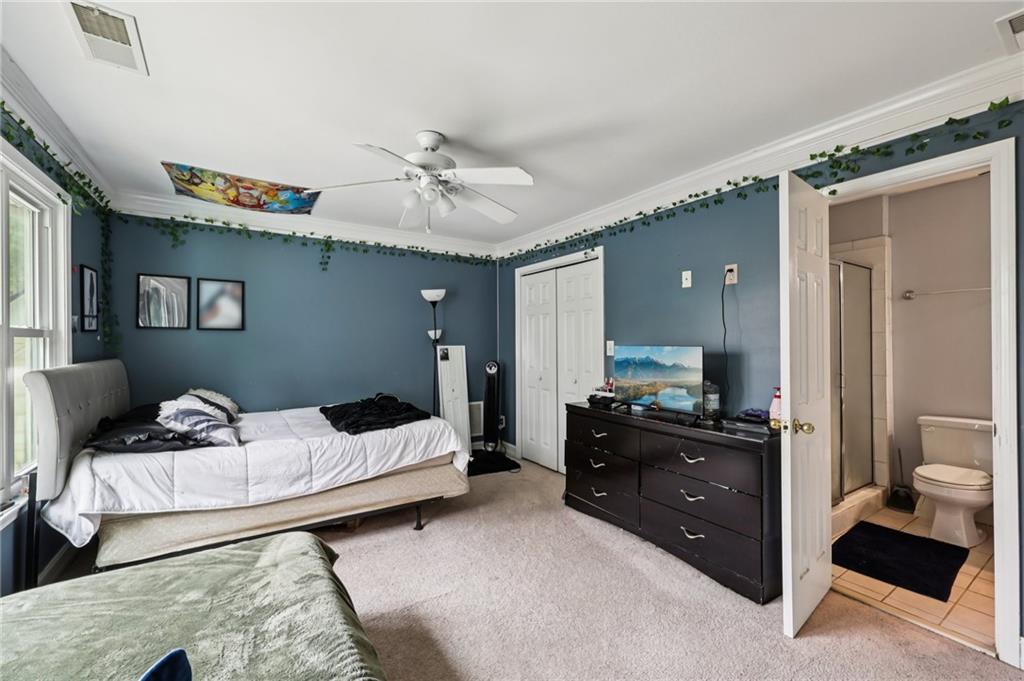 436 Lancelot Trail McDonough, GA 30252 - Photo 28 of 49 a bedroom with a bed and a chandelier
