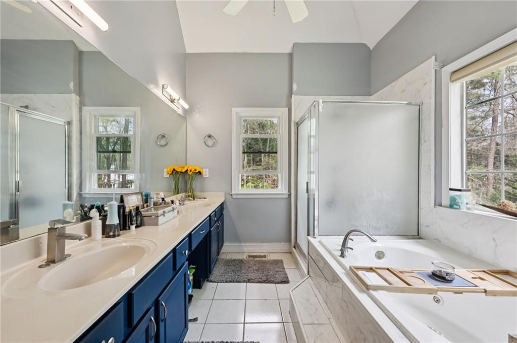 436 Lancelot Trail McDonough, GA 30252 - Photo 30 of 49 a bathroom with a tub a sink and a large mirror
