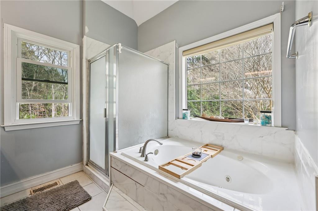 436 Lancelot Trail McDonough, GA 30252 - Photo 31 of 49 a bathroom with a tub and a window