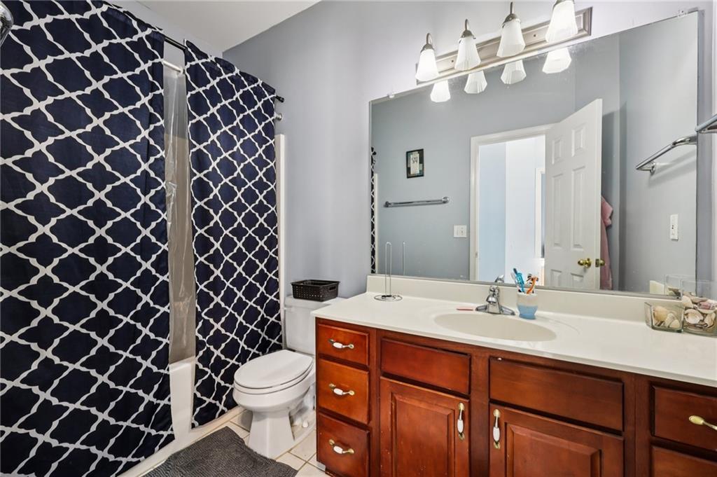 436 Lancelot Trail McDonough, GA 30252 - Photo 38 of 49 a bathroom with a sink a toilet a mirror and shower
