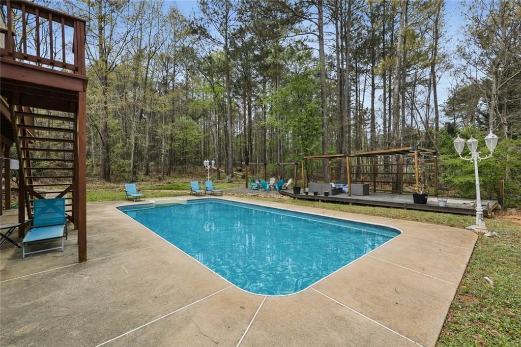 436 Lancelot Trail McDonough, GA 30252 - Photo 8 of 49 a view of a swimming pool with a patio