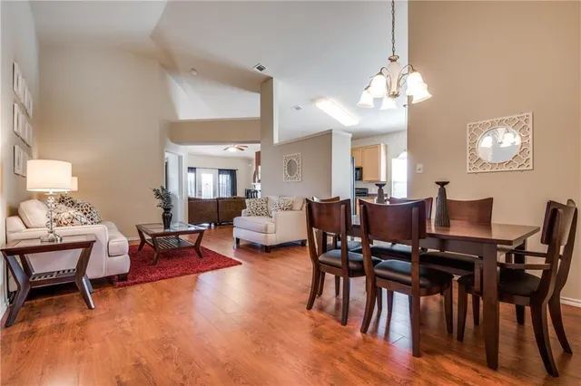 a view of a dining room with furniture and chandelier
