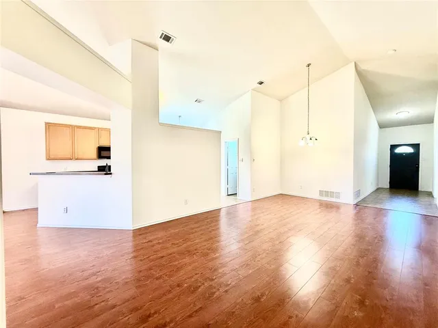 a view of a kitchen with wooden floor and a sink