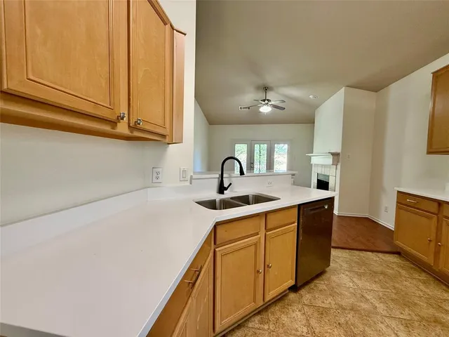a kitchen with stainless steel appliances granite countertop a sink and dishwasher a stove with wooden floor