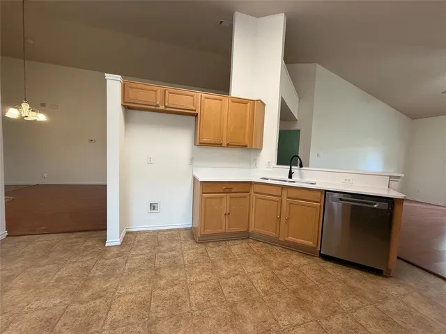 a kitchen with a sink stove and cabinets