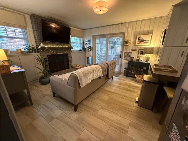 a living room with furniture fireplace and flat screen tv