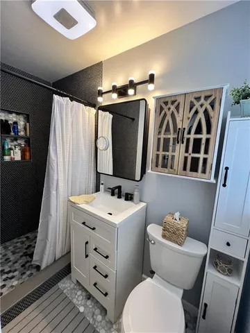 a bathroom with a toilet sink and mirror