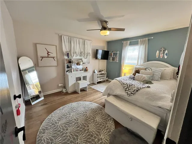 a bedroom with a bed a couch and dresser