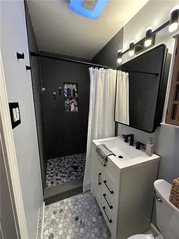 a bathroom with a sink toilet and shower