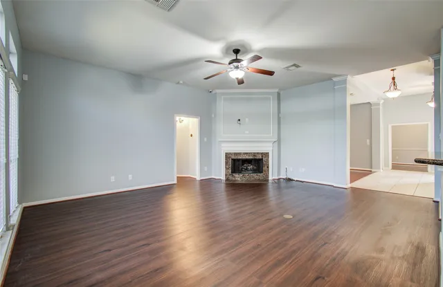 a view of a kitchen with a sink a fireplace and wooden floor
