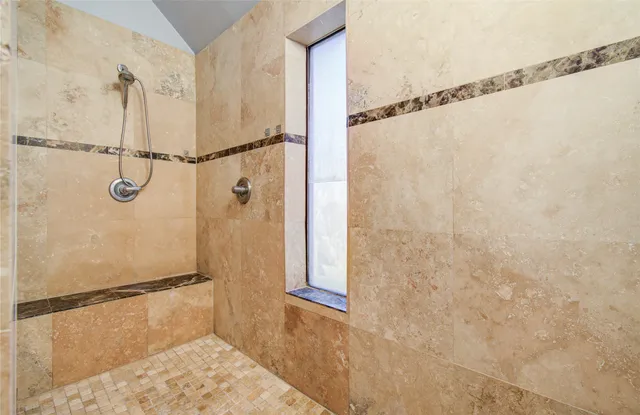 a view of a kitchen with a stove a chandelier fan and refrigerator