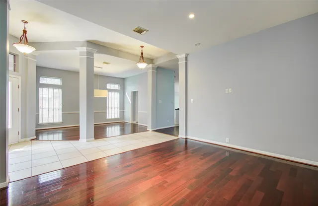 a view of a room with wooden floor and window