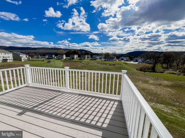 a view of a balcony with wooden floor