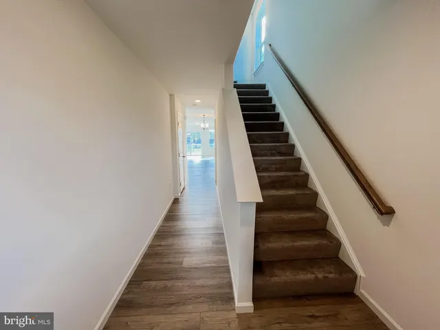 a view of entryway and hall with wooden floor