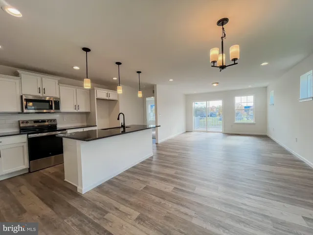 a large kitchen with stainless steel appliances kitchen island a large island in the center