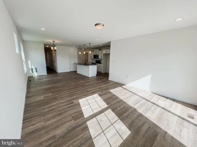 a view of a living room with kitchen and furniture